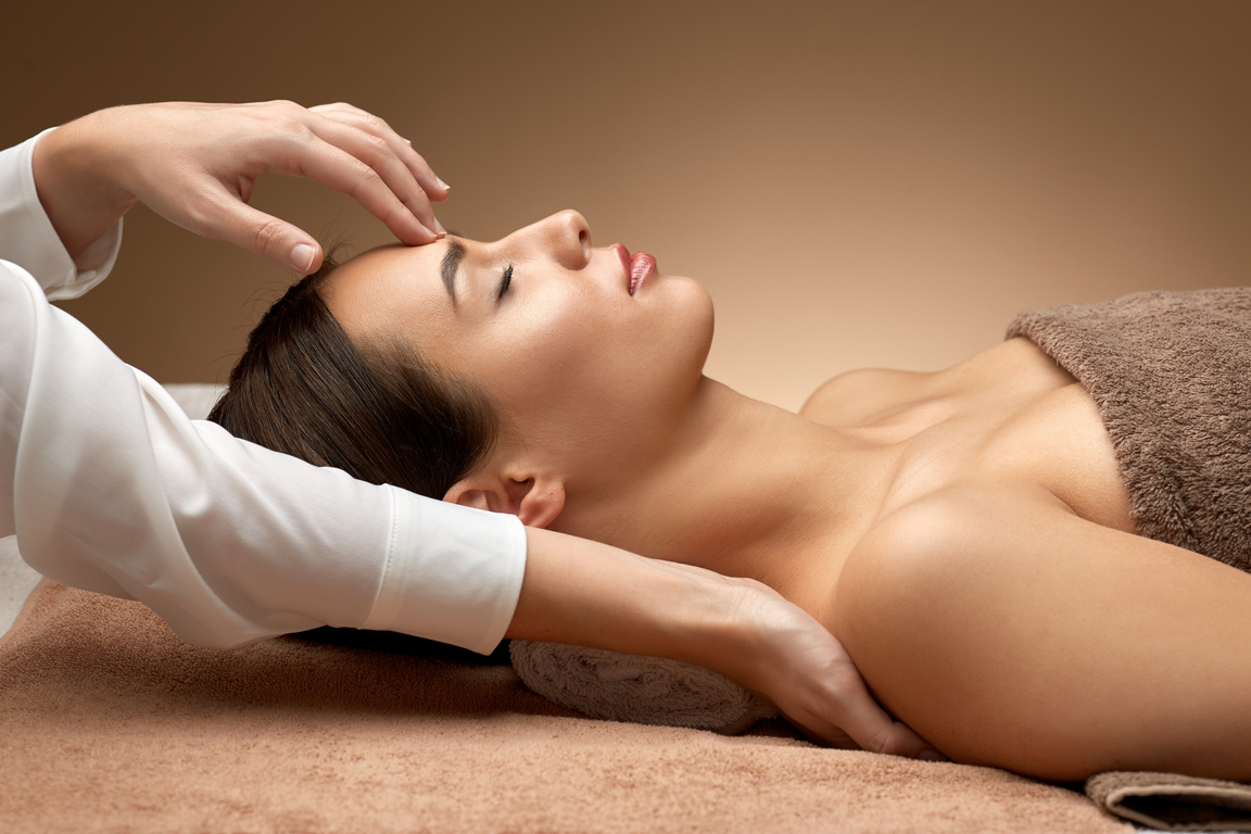 Woman Having Face and Head Massage at Spa